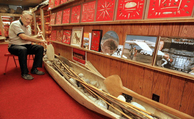 Don Miller in 1998 in his basement museum with a dugout canoe from South America