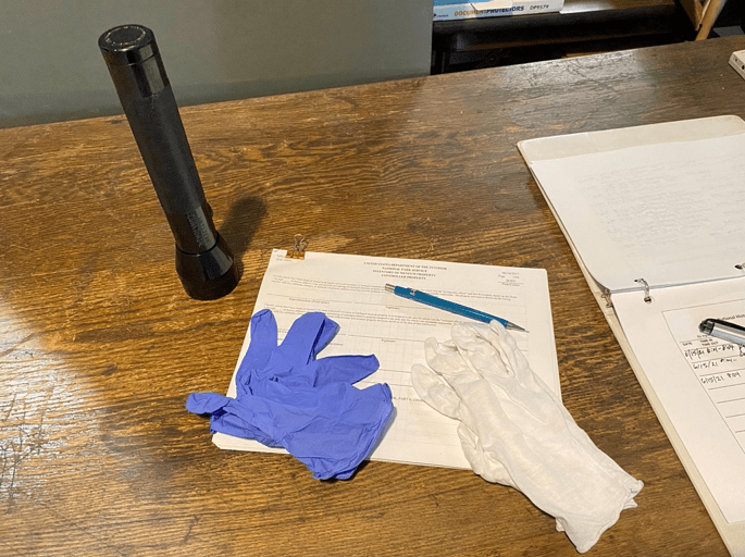Inventory list, pencil, gloves and a flashlight